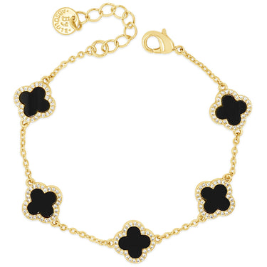 Gold bracelet with black clover-shaped charms on a white background