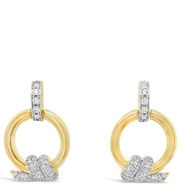 Gold and silver earrings on a white background