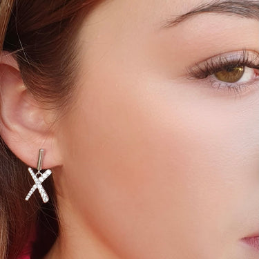Close-up of a person wearing a star-shaped earring with a blurred background
