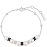 Pearl bracelet with black and white butterfly charms on a white background