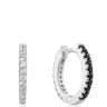 Silver hoop earrings with black and clear gemstones on a white background