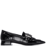 Black patent leather loafer with a decorative buckle on a white background