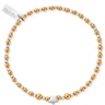 Bracelet with gold and silver beads and a star charm on a white background
