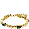 Gold bracelet with green and clear gemstones on a white background