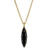 Gold necklace with a black pendant on a white background