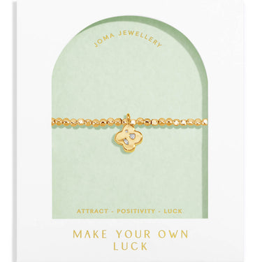 Gold bracelet on a Joma Jewellery card with text on a white background