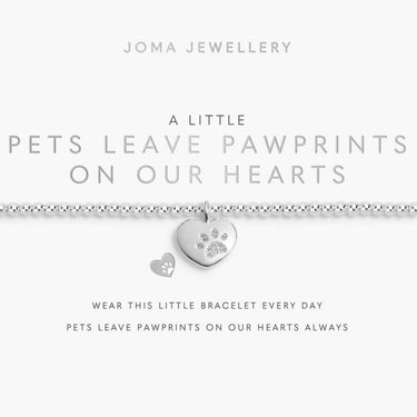 Silver bracelet with heart and paw print charm on a Joma Jewellery card.