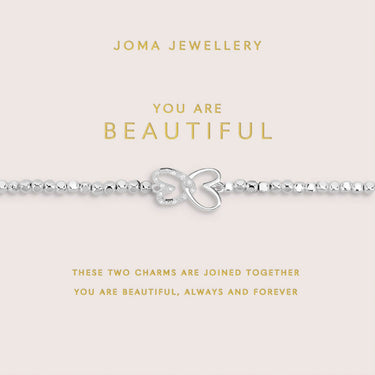 Silver bracelet with charms on a Joma Jewellery card