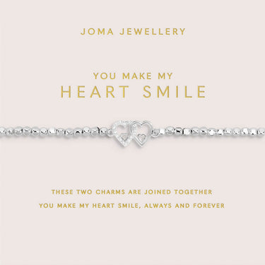 Joma Jewellery bracelet with heart charms on a pink card