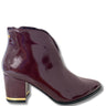 Patent leather ankle boot with a block heel on a white background