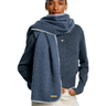 Person wearing a blue sweater with a matching scarf on a white background