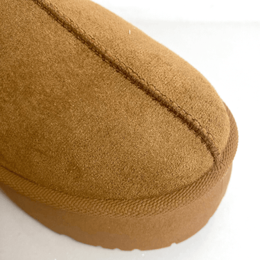Close-up of a brown slippers sole on a white background