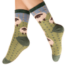 Green socks with sheep pattern worn by a person on a white background