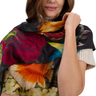 Woman wearing a colorful floral scarf with a white background
