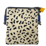 Small pouch with black abstract pattern on beige fabric, blue straps, and yellow tag.