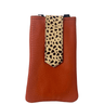 Brown leather phone case with a cheetah print strap on a white background