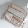 Open jewelry organizer with jewelry items on a light gray background