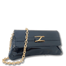 Black handbag with a gold chain on a white background