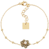 Gold bracelet with a floral charm and square tag on a white background