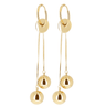 Gold hoop earrings with dangling gold balls on a white background