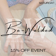 Promotional graphic for a jewelry event showing multiple hands wearing delicate gold bracelets and rings on a light wood table, with overlaid text reading 'SATURDAY', 'Be-Welded', 'PERMANENT JEWELLERY', and '15% OFF EVENT'.