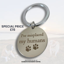 Keychain with 'I've misplaced my humans' text and paw prints on a white background