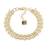 A gold multi-strand chain link bracelet with a lobster clasp and a small square brand tag that reads '7AG Super'. The tag is visible on a clean, light off-white background.
