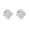 A pair of silver stud earrings with a geometric, diamond-like openwork pattern, shown on a light gray reflective background.