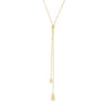 A gold lariat necklace with a flat chain, a small circular medallion, and two long dangling chains ending in teardrop-shaped polished pendants, shown against a light gray background.