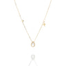 A delicate gold necklace featuring a teardrop-shaped pearl pendant, a small star charm, and a tiny round pearl accent on a light gray background.