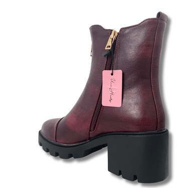 Burgundy ankle boot with a pink tag on a white background