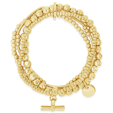 Gold beaded bracelet with a toggle clasp on a white background