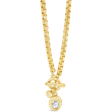 Gold necklace with a round pendant on a white background
