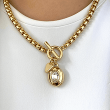 Gold necklace with a pendant on a white background
