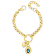 Gold bracelet with heart and blue gemstone charm on a white background
