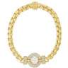 Gold bracelet with a central gemstone on a white background