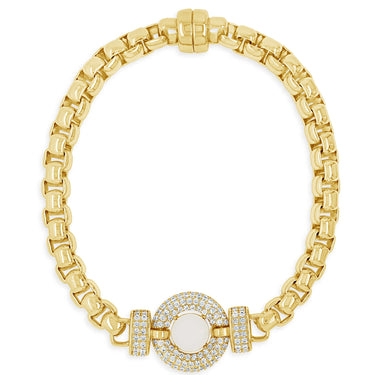 Gold bracelet with a central gemstone on a white background