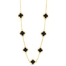 Gold necklace with black clover-shaped pendants on a white background