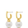 A pair of gold hoop earrings with a dangling white pearl, shown against a plain white background.