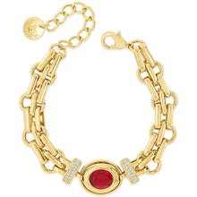 Gold chain bracelet with a red gemstone and clear stones on a white background