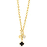 Gold necklace with black clover charm on a white background