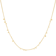 Gold necklace with small beads on a white background