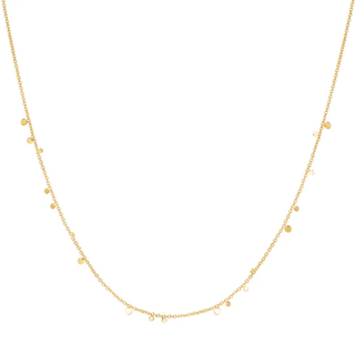Gold necklace with small beads on a white background