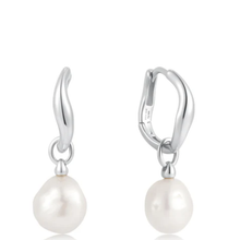 Pair of pearl earrings with silver hooks on a white background
