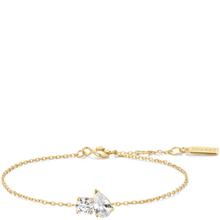 Gold bracelet with a clear gemstone on a white background