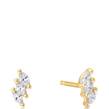 Gold earrings with clear gemstones on a white background