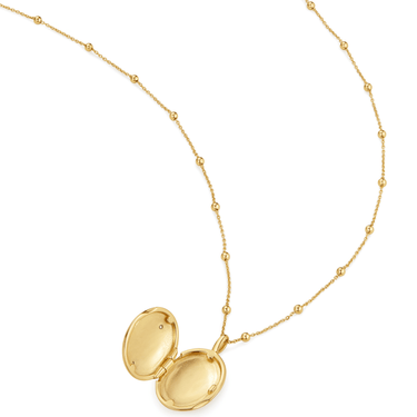 Gold necklace with a locket on a white background
