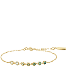 Gold bracelet with green gemstones on a white background