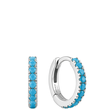Silver hoop earrings with turquoise stones on a white background