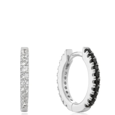 Silver hoop earrings with black and clear gemstones on a white background